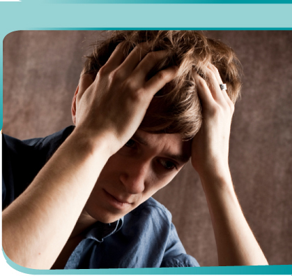 Young man with head in his hands who appears to be under stress or very concerned.